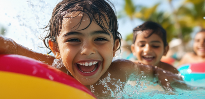 Kids in the pool shouting and smiling 